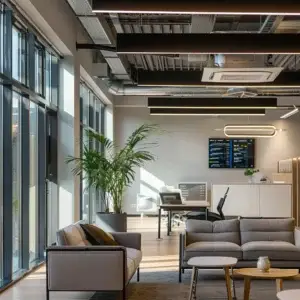 a sleek, modern office equipped with a high-efficiency air conditioning system, showcasing a digital thermostat displaying a comfortable climate setting, illuminated by bright overhead lights and featuring stylish, contemporary furnishings.